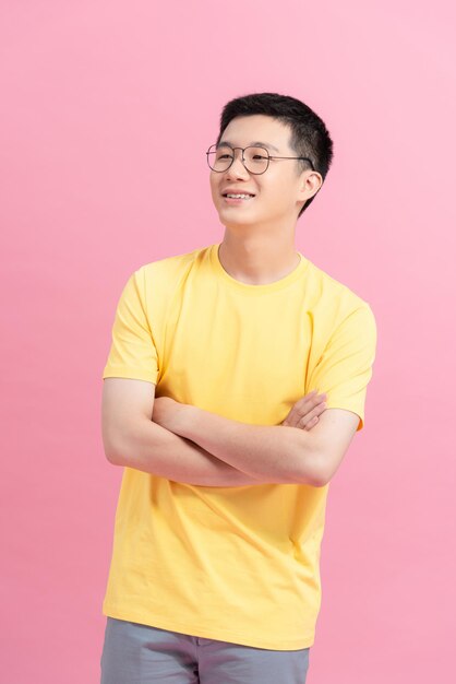 Portrait of a handsome Asian man with glasses crossing his arms