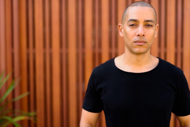 Portrait of handsome bald man in the street