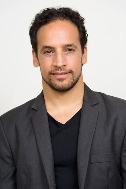 Portrait of handsome bearded Hispanic businessman in suit