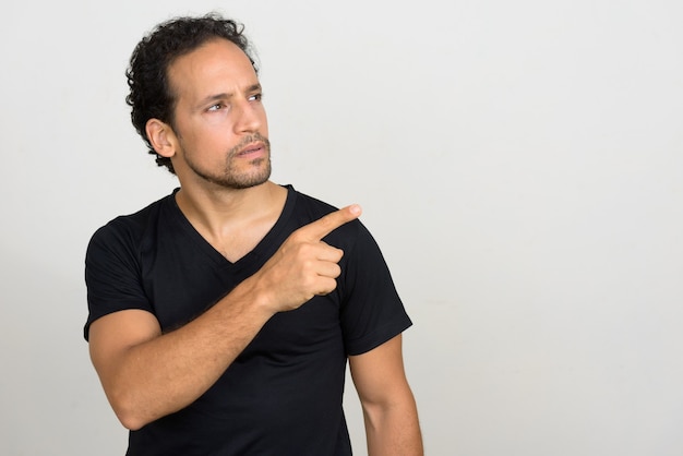 Portrait of handsome bearded Hispanic man with curly hair