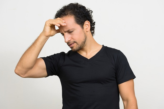 Portrait of handsome bearded Hispanic man with curly hair