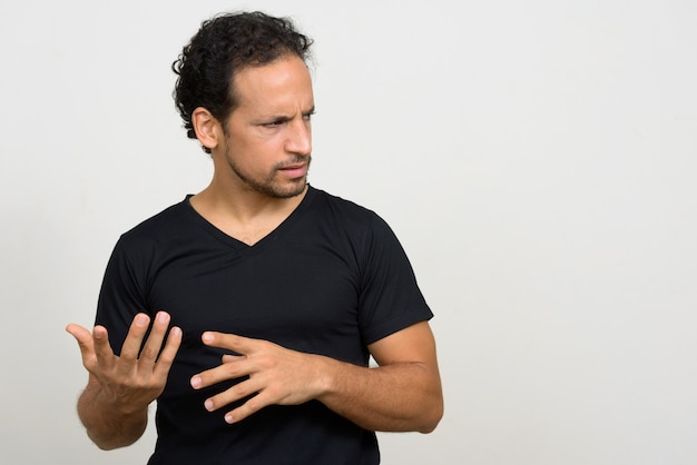 Portrait of handsome bearded Hispanic man with curly hair