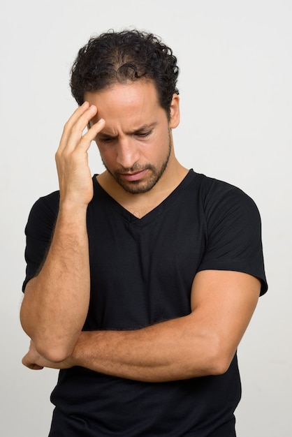 Portrait of handsome bearded Hispanic man with curly hair