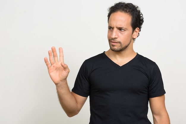 Portrait of handsome bearded Hispanic man with curly hair