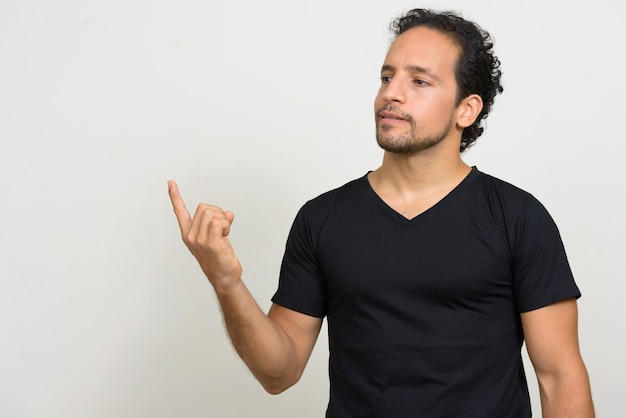 Portrait of handsome bearded Hispanic man with curly hair