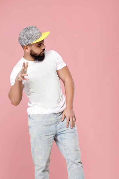 Portrait of handsome bearded man in cap dancing