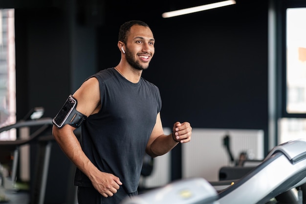 Portrait Of Handsome Black Male Athlete Exercising On Treadmill At Gym