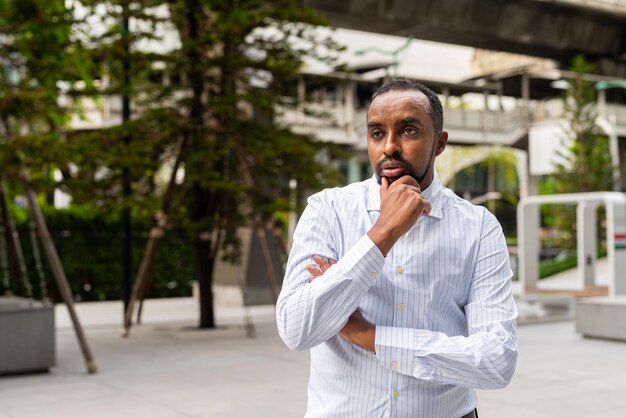 Portrait of handsome black man in city ready for business