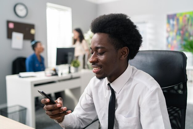 Portrait of handsome boss dressed in white shirt black tie pants guy with afro manager sits at desk