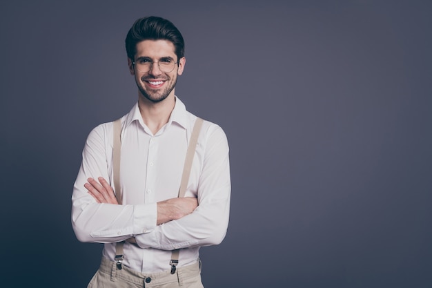 portrait of handsome business man hands crossed toothy beaming smiling young chief dressed formalwear white shirt beige suspenders specs .