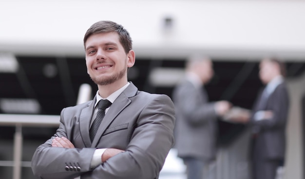 Portrait of handsome businessman on blurred office background