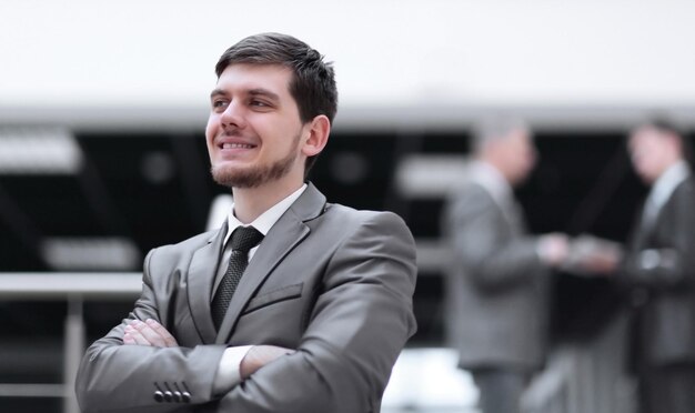 Portrait of handsome businessman on blurred office background