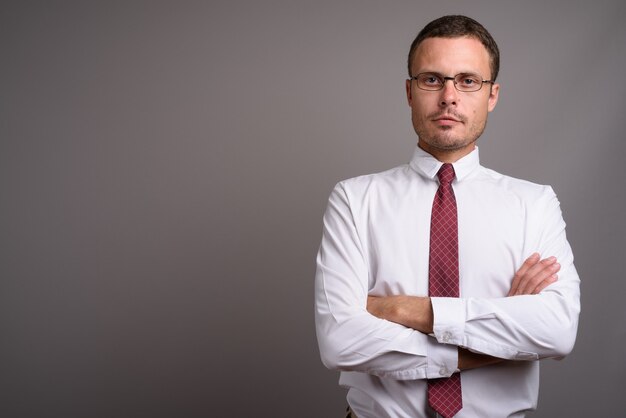 Portrait of handsome businessman on gray