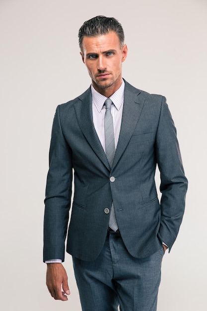 Portrait of a handsome businessman in suit standing isolated