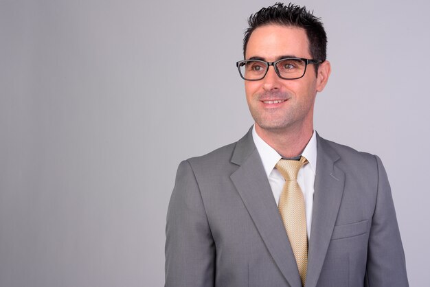 portrait of handsome businessman wearing suit on white