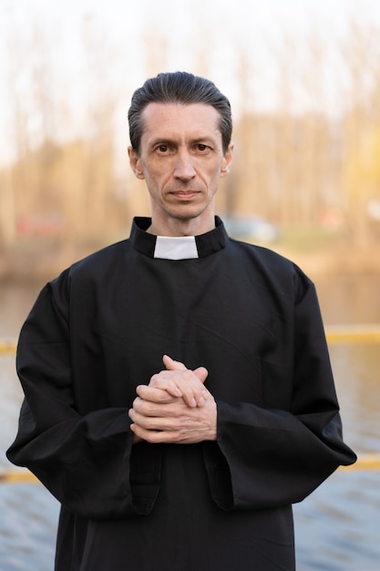 Portrait of handsome catholic priest or pastor with collar