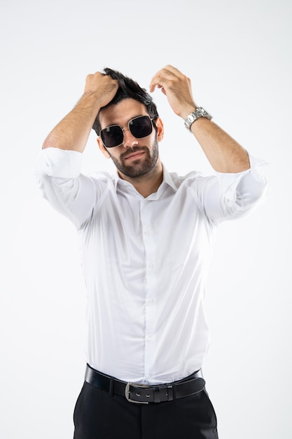 Portrait handsome Caucasian man wearing black glasses, sunglasses, standing hair style and looking at the camera shot in a studio with setting the light on white background.