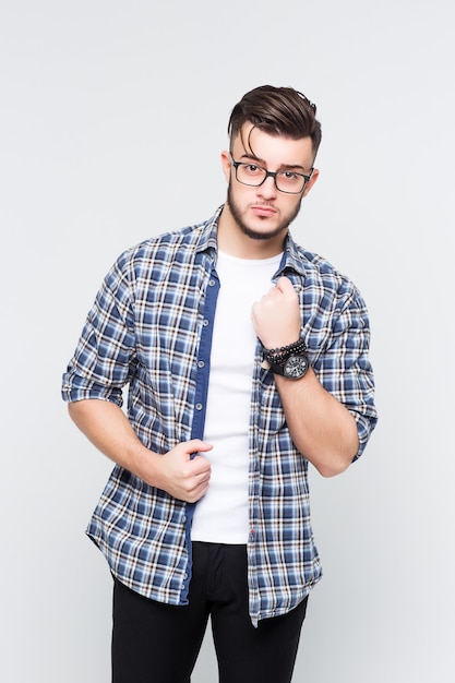 Portrait of handsome and confident friendly-looking male with beard and  standing in elevetor over white wall