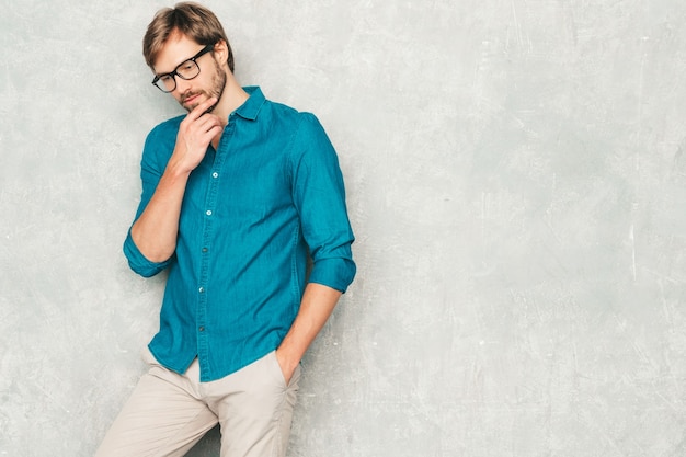 Portrait of handsome confident hipster lumbersexual businessman model wearing casual jeans shirt clothes. 