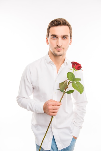 Portrait of handsome cute boy with red rose