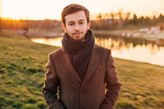 Portrait handsome elegant bearded man wearing brown coat in spri