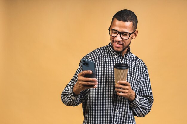 Portrait of handsome excited thinking serious african american guy sending and getting messages