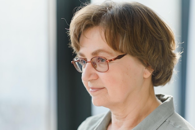 Portrait of handsome grandmother at home