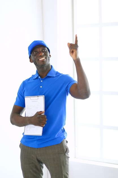 Portrait of an handsome happy deliverer with folder