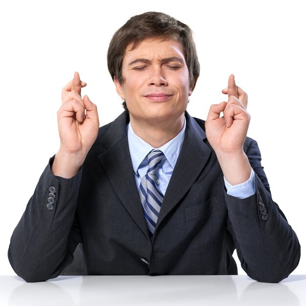 Portrait of handsome happy young man sitting with laptop with arms outstretched isolated on white