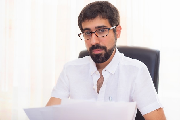 Portrait of a handsome hipster guy working at the office