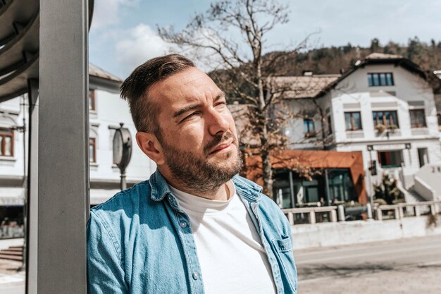 Portrait of a handsome hipster man in a jean jacket in a big city on the street a life style