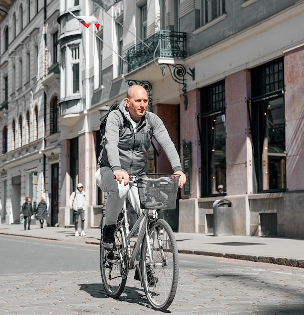 Portrait of a handsome hipster man A man in a big city in the street with a bicycle a life style