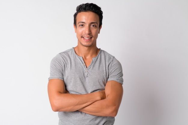 Photo portrait of handsome hispanic man against white wall