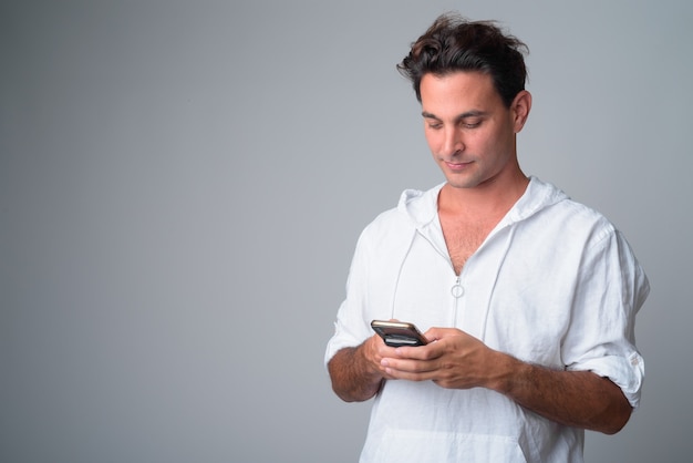 Portrait of handsome Hispanic man using phone