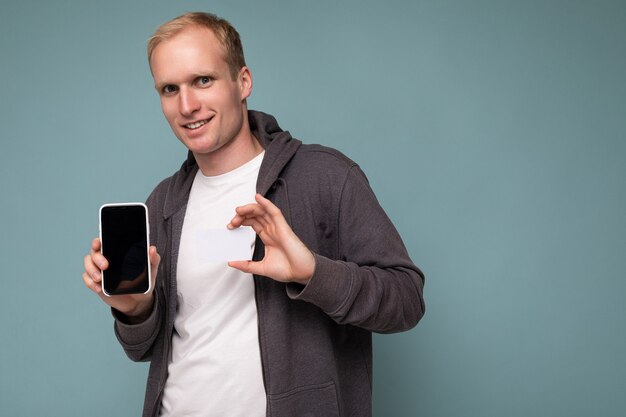 Portrait of handsome holding smartphone and credit card