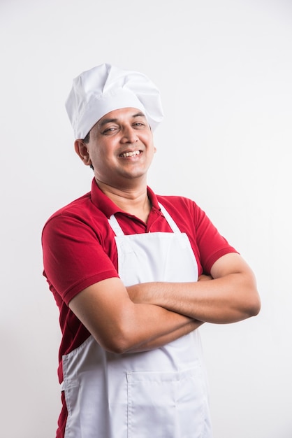 Portrait of handsome Indian male chef posing while doing activities