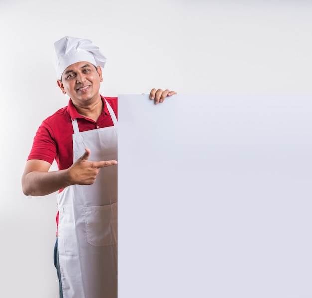 Portrait of handsome Indian male chef posing while doing activities