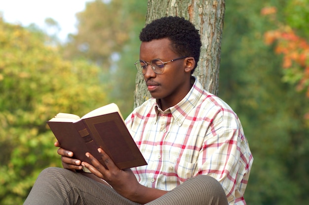 Photo portrait of handsome intelligent black african man young afro american guy in glasses and shirt is