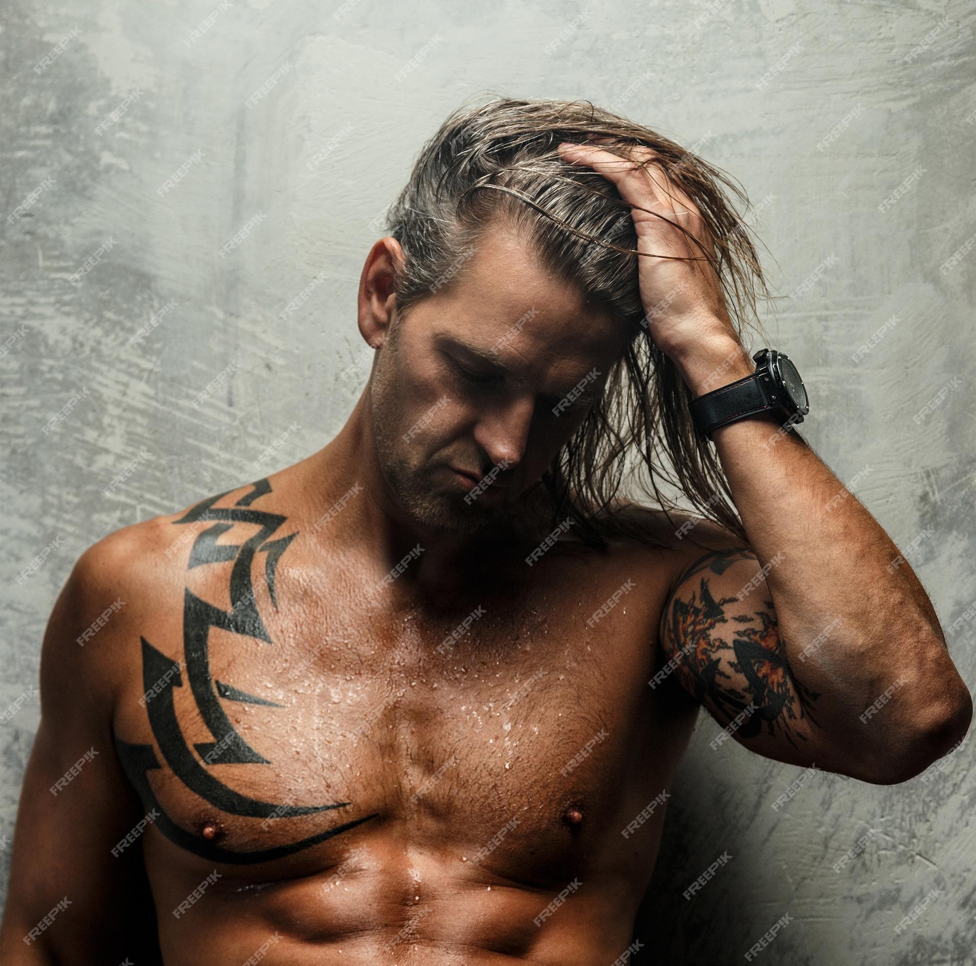 Premium Photo | Portrait of handsome long-haired man with naked torso. isolated on gray background. tattoed male body. Premium Photo | Portrait of handsome long-haired man with naked torso. isolated on gray background. tattoed male body.