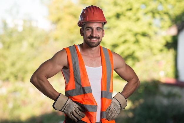 Portrait Of Handsome Male Architect Engineer With Red Helmet