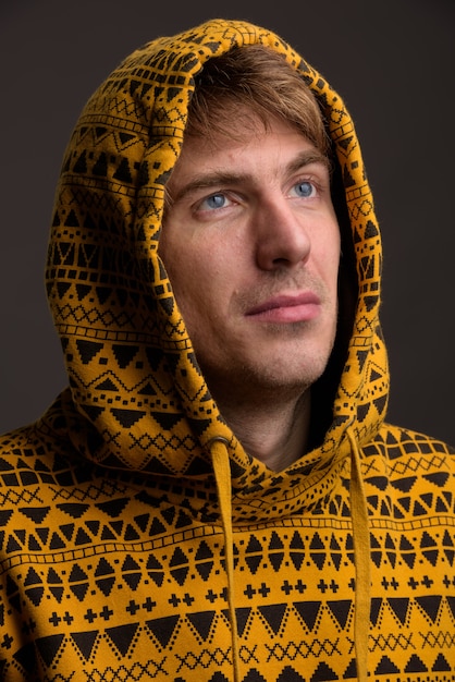 Portrait of handsome man against gray wall