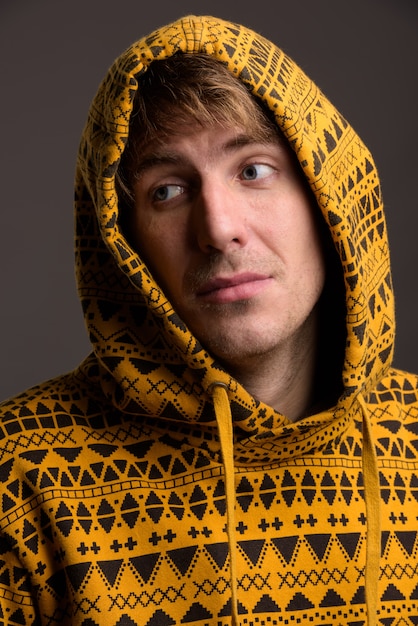 Portrait of handsome man against gray wall