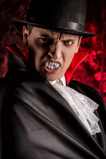 portrait of handsome man dressed in a dracula costume for halloween
