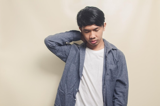 Portrait of handsome man in gray shirt with gloomy and sad expression