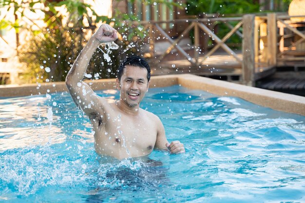 Portrait of a handsome man posing in the pool