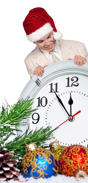 Portrait of handsome man in santa hat with clock on white background