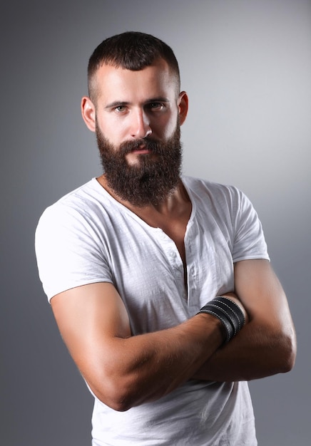 Portrait of handsome man standing isolated on grey background