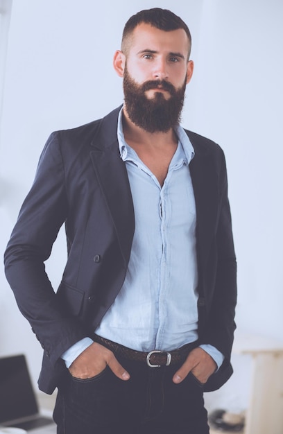 Portrait of handsome man standing isolated on grey background