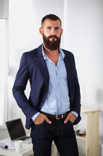 Portrait of handsome man standing isolated on grey background