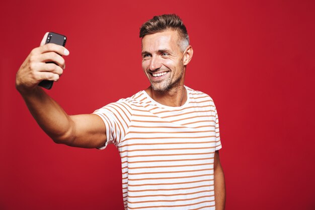 Portrait of a handsome man standing on red